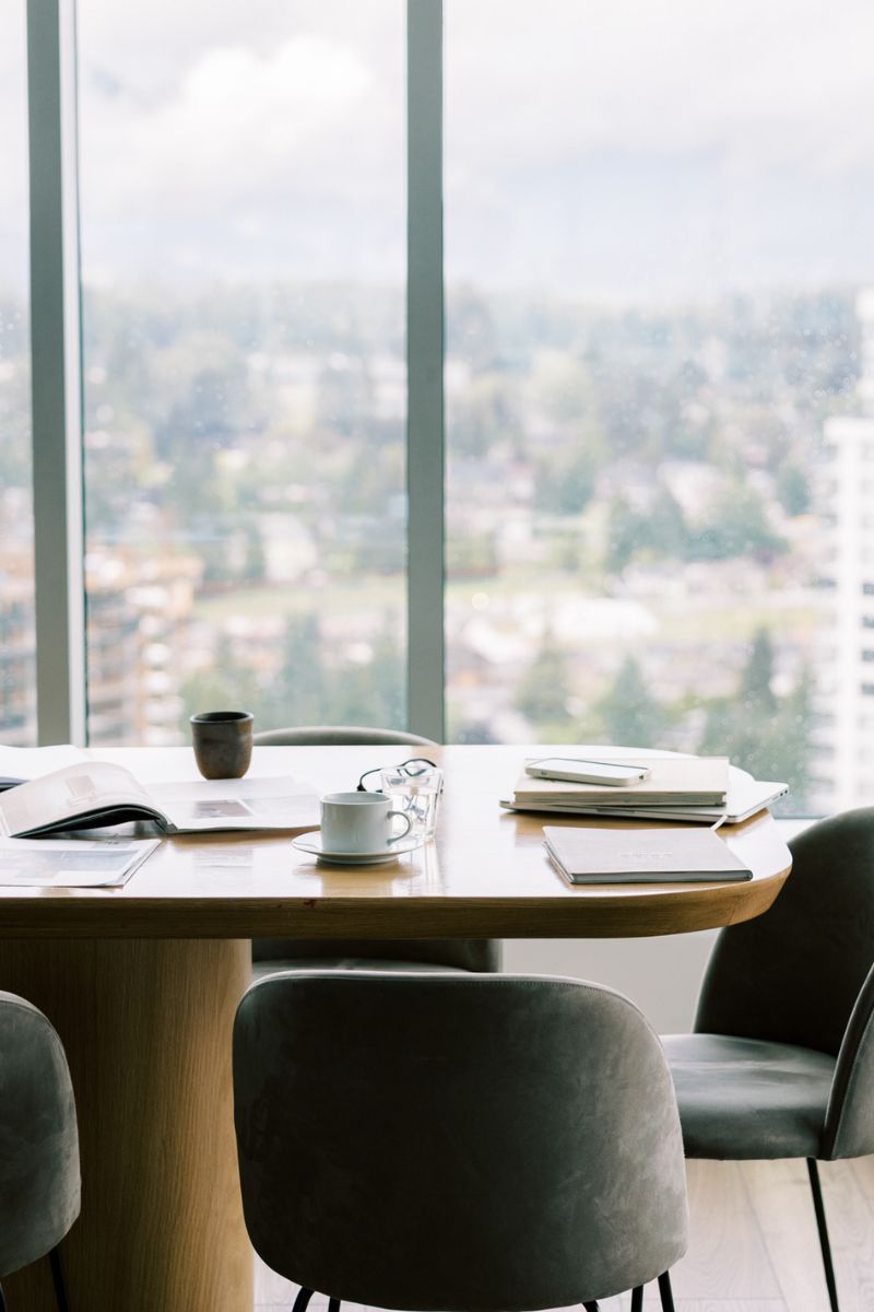 Bright workspace with a table and chairs overlooking a city